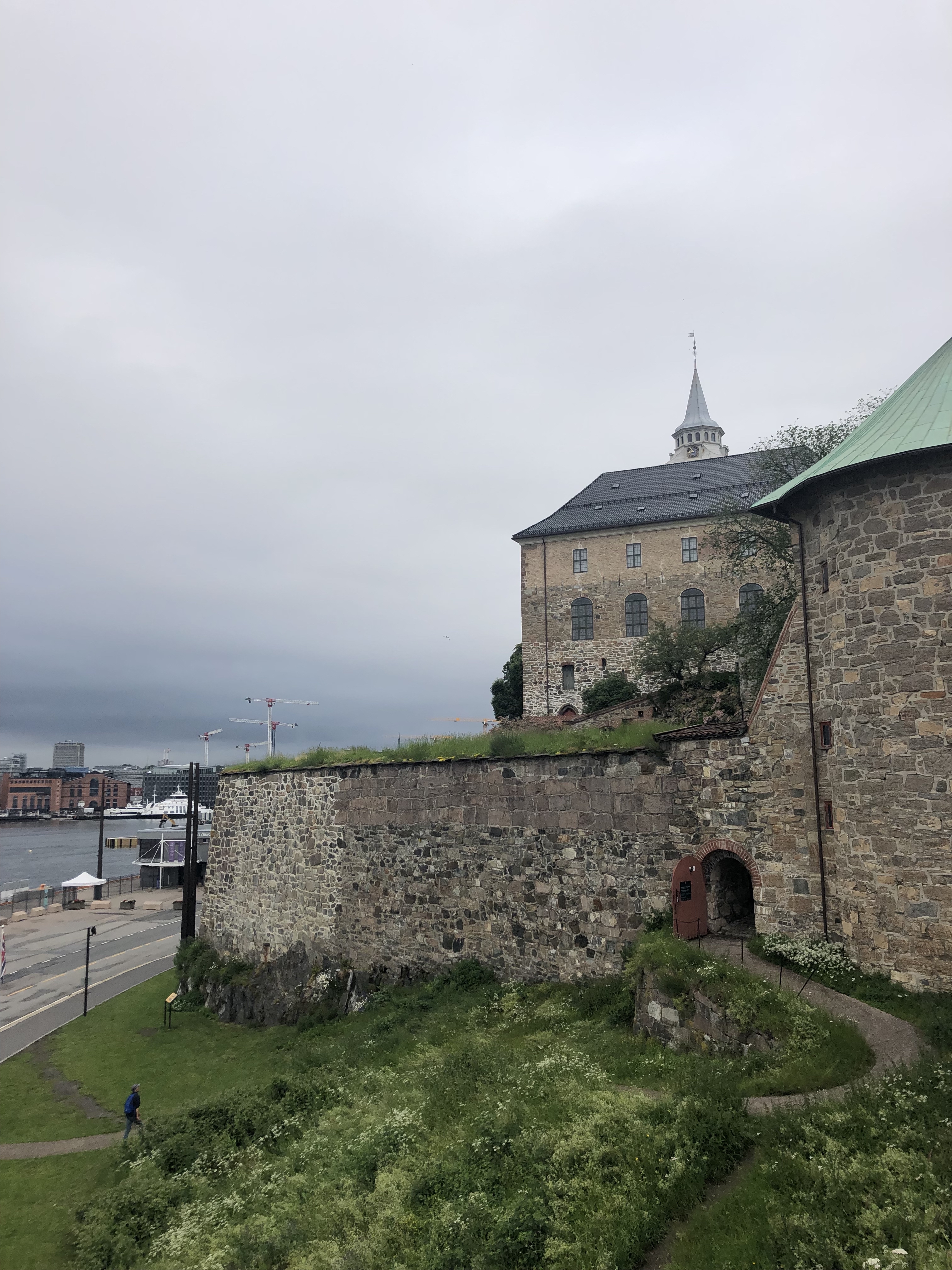 Castle in Oslo. Brick and cobblestone building with gray skies behind it.