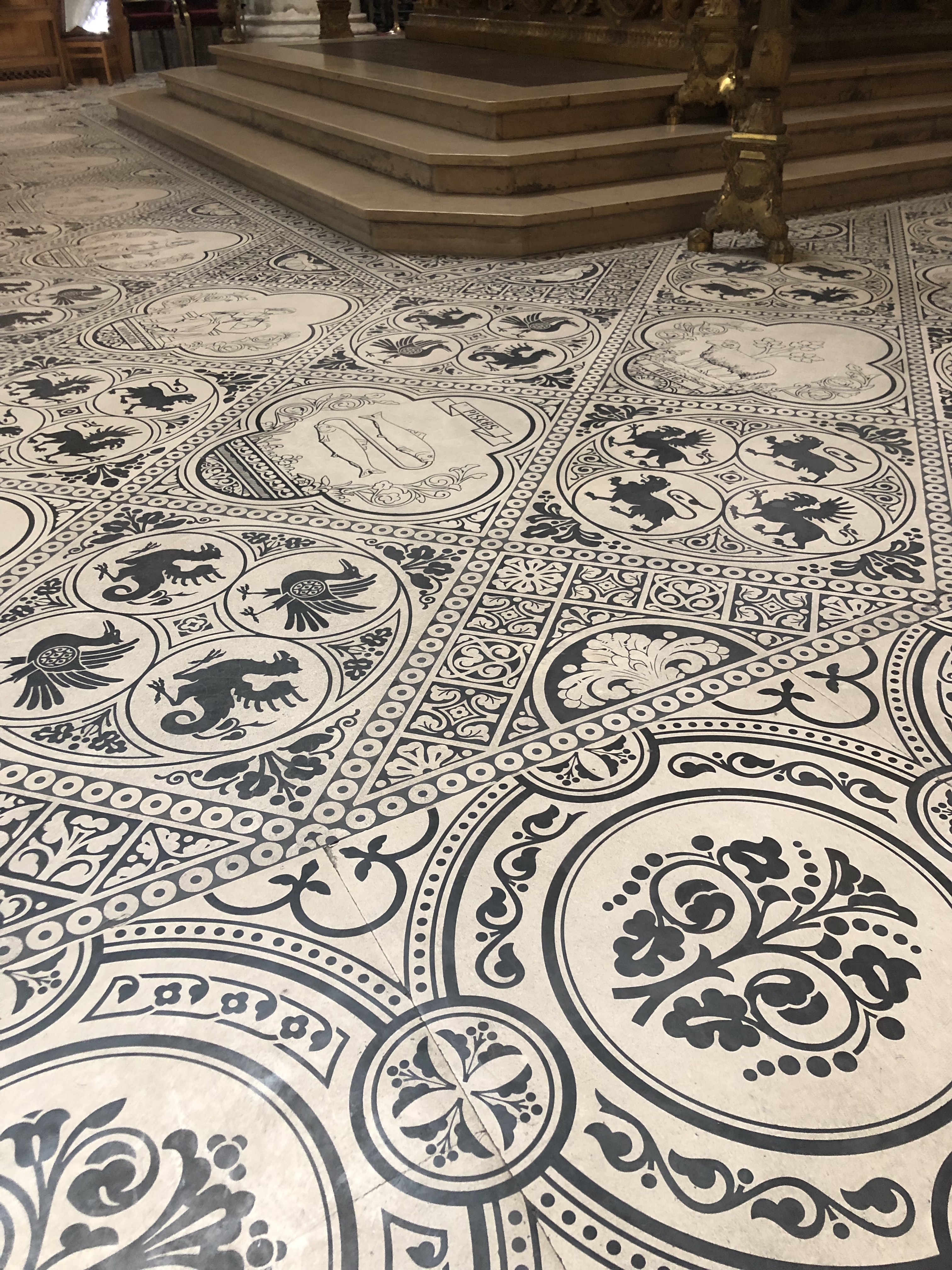 Floor of a church in Brussels with blue painted symbols