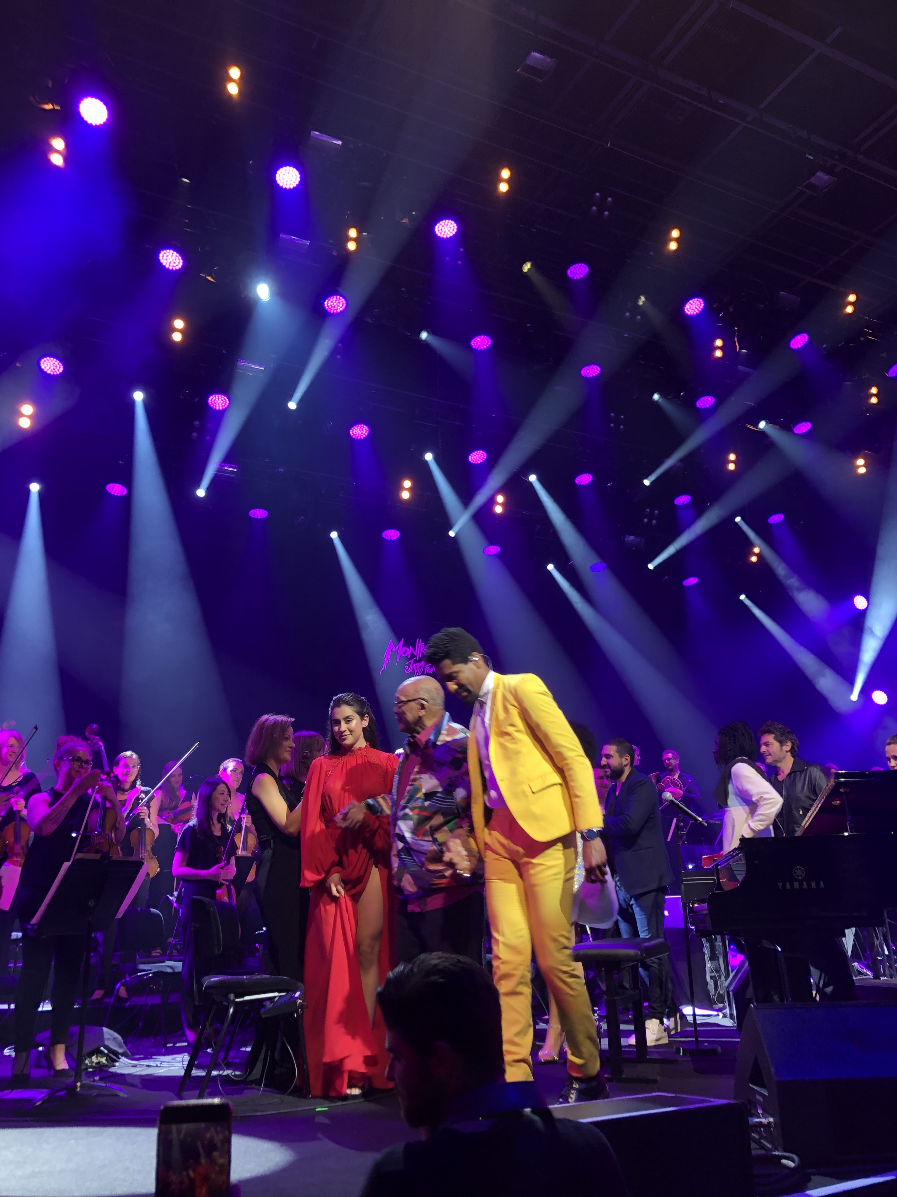 John Batiste escorting Quincy Jones off the stage