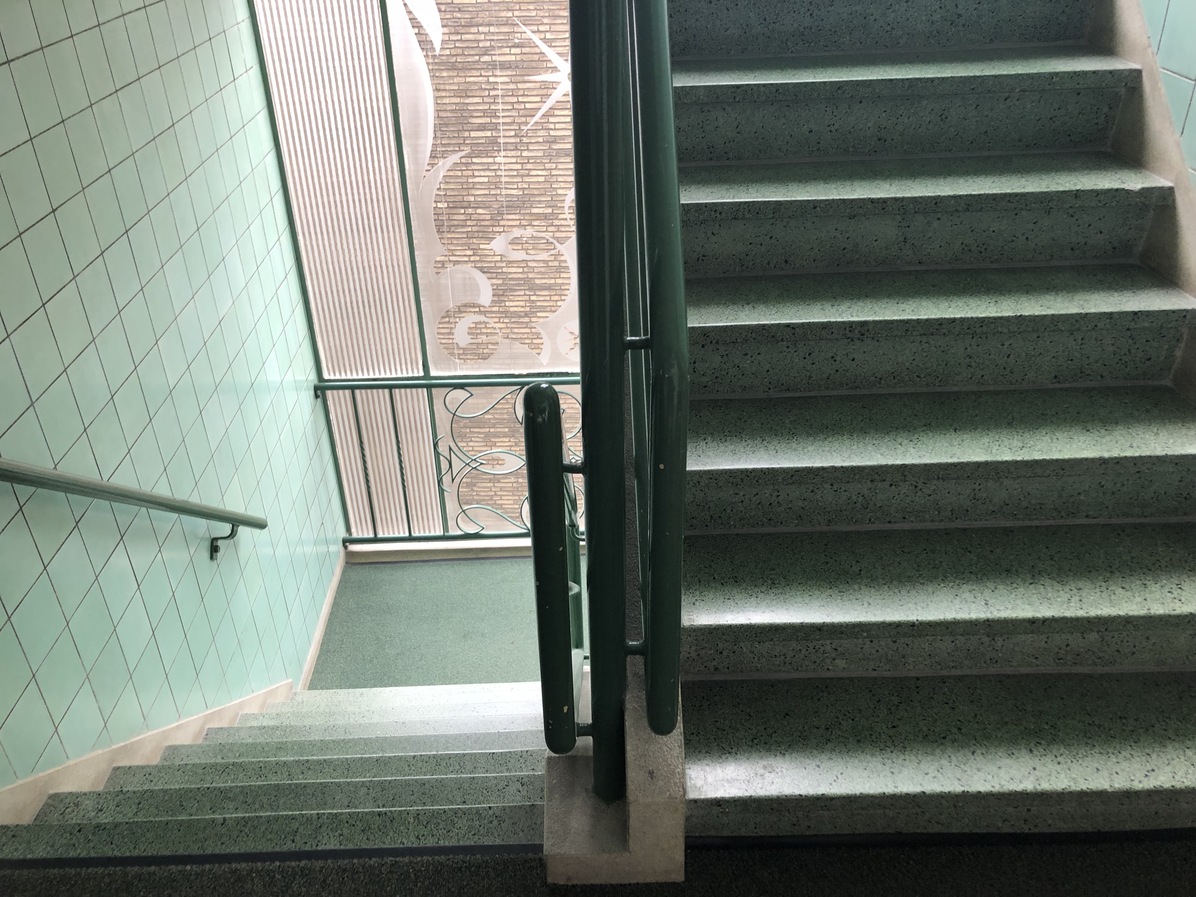 Turquoise staircase with turquoise tile walls