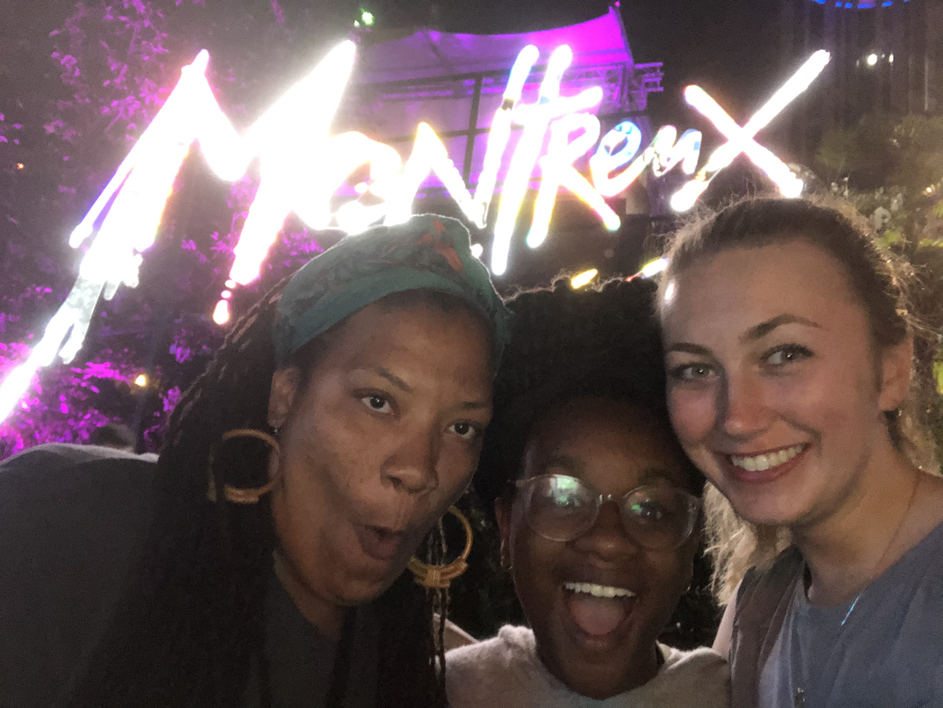 Three women in front of a sign at the montreux jazz fest